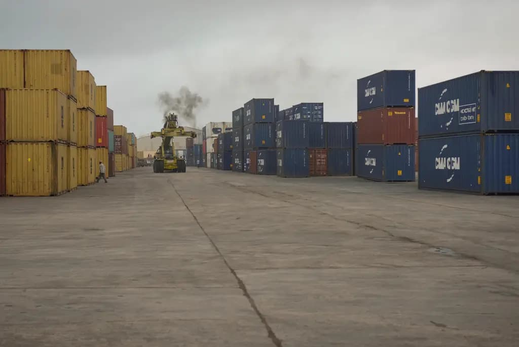 A reach stacker moving containers through a depot yard